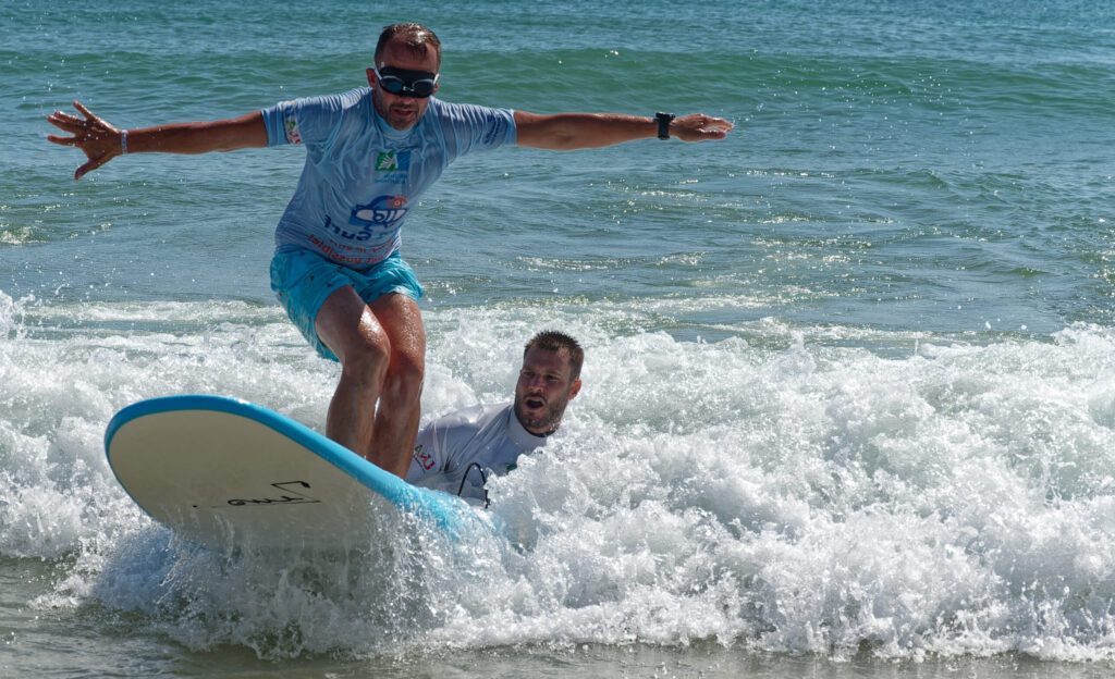 photo d’un voyant avec des lunettes occultantes en train de surfer
